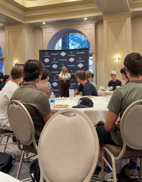 Nickey Norrish speaking to a room of young hockey players